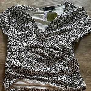 Cute soft shirt with cross in the frount. New with tags